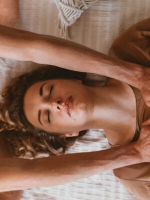 A woman receiving Reiki therapy for relaxation and wellness in a serene setting.